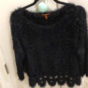 Black fuzzy sweater with design on bottom